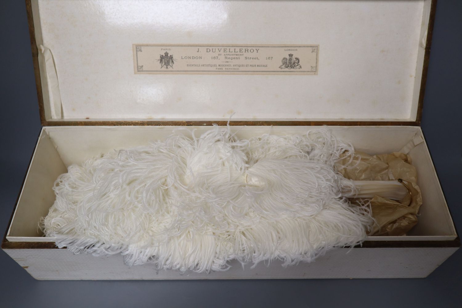 An ostrich feather fan with mother of pearl sticks, in J. Duvelleroy box, Regent Street, fan height 46cm